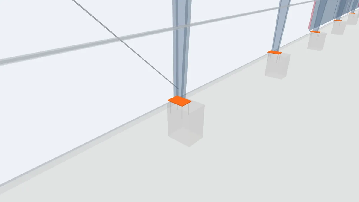 Close-up of a column base plate on a concrete footing with anchor bolts in the PEB model